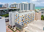 Thumbnail 33 of 37 - Bird’s-eye view of a Miami Beach apartment complex highlighting the urban setting and building layout.