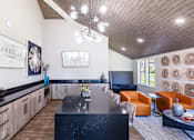 Thumbnail 23 of 28 - a kitchen and living room with a table and chairs