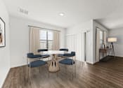 Thumbnail 11 of 35 - A dining room with a round table and chairs.