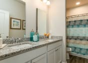 Thumbnail 23 of 62 - a bathroom with a sink and a mirror