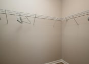 Thumbnail 24 of 62 - a walk in closet in a bedroom
