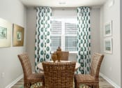 Thumbnail 34 of 62 - a round table with four chairs in front of a window with curtains