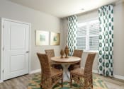 Thumbnail 35 of 62 - a dining room with a table and four chairs