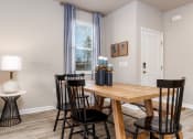 Thumbnail 17 of 62 - a dining room with a table and chairs