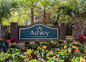Thumbnail 3 of 29 - Ashley Lakehouse monument sign at apartment community entrance with palm trees and colorful landscaping in West Ashley, Charleston, SC.