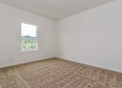Thumbnail 73 of 75 - A room with a carpeted floor and a window.
