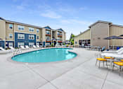 Thumbnail 33 of 47 - our apartments have a resort style pool with chairs and umbrellas