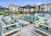 Thumbnail 28 of 47 - our apartments feature a pool and lounge area with furniture and tables