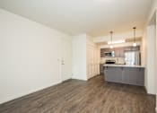 Thumbnail 6 of 47 - an empty living room and kitchen with a stainless steel refrigerator
