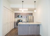 Thumbnail 4 of 47 - a kitchen with stainless steel appliances and a counter top