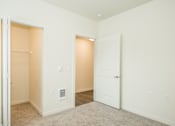 Thumbnail 12 of 47 - a bedroom with an open door and a closet