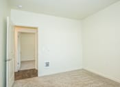 Thumbnail 13 of 47 - an empty room with white walls and a door to a hallway