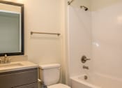 Thumbnail 15 of 47 - a bathroom with a toilet and a tub and a sink