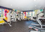 Thumbnail 25 of 47 - Pet-Friendly Luxury Apartments in Vancouver, WA - Autumn Grove - Fitness Center with Treadmills, Free Weights, Strength Training Equipment, Workout Benches, and Windows.