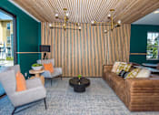 Thumbnail 20 of 47 - a living room with green walls and a brown couch and chairs