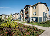 Thumbnail 42 of 47 - an exterior view of a row of apartment buildings with a sidewalk