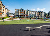 Thumbnail 36 of 47 - an empty park with a playground in front of an apartment building
