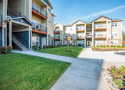 Thumbnail 10 of 47 - the preserve at ballantyne commons apartments exterior with sidewalk and green grass