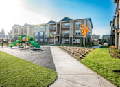 Thumbnail 37 of 47 - the preserve at ballantyne commons park with playground and apartment buildings
