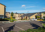 Thumbnail 46 of 47 - an empty parking lot in front of an apartment complex