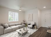 Thumbnail 37 of 38 - A living room with a grey sofa, a white armchair, a coffee table, and a rug.