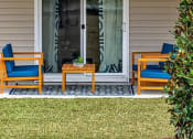 Thumbnail 28 of 62 - a porch with two chairs and a table