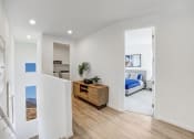 Thumbnail 4 of 41 - a living room with a bed and a wooden floor