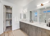 Thumbnail 15 of 41 - a bathroom with two sinks and a shower and a mirror