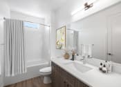 Thumbnail 11 of 41 - a bathroom with a shower and a sink and a mirror