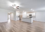 Thumbnail 8 of 46 - an open kitchen and living room with a ceiling fan