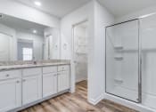 Thumbnail 11 of 46 - a white bathroom with a shower and a sink