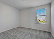 Thumbnail 30 of 36 - A room with a window and a grey carpet.