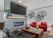 Thumbnail 15 of 18 - Blue Sky Landing apartments clubhouse living room with comfortable seating, fireplace and pet-friendly resident lounge near Old National Parkway in College Park, GA close to South Fulton and Hartsfield-Jackson Atlanta International Airport.