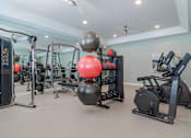 Thumbnail 11 of 18 - Modern resident fitness center with free weights and exercise equipment at Blue Sky Landing apartments in College Park, GA near South Fulton and Camp Creek.