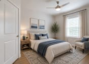 Thumbnail 8 of 18 - Bright guest bedroom at Blue Sky Landing featuring a spacious layout, ceiling fan, plush carpeting, and natural light in a thoughtfully designed apartment home in College Park, GA.
