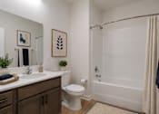 Thumbnail 7 of 18 - Modern bathroom at Blue Sky Landing featuring a spacious vanity, full-size bathtub and shower, contemporary fixtures, and stylish finishes in a brand-new apartment home in College Park, Georgia.