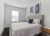 Thumbnail 14 of 30 - Boatman Hammock Townhomes in Lake Worth, FL photo of a bedroom with a large bed and a window