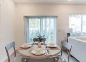 Thumbnail 11 of 30 - Boatman Hammock Townhomes in Lake Worth, FL photo of a dining room with a table and chairs and a window