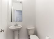 Thumbnail 24 of 30 - Boatman Hammock Townhomes in Lake Worth, FL photo of a bathroom with a sink toilet and a mirror