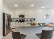 Thumbnail 5 of 30 - Boatman Hammock Townhomes in Lake Worth, FL photo of a kitchen with stainless steel appliances and a granite counter top