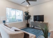 Thumbnail 10 of 30 - Boatman Hammock Townhomes in Lake Worth, FL photo of the living room of an apartment with a couch and a tv