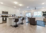 Thumbnail 7 of 30 - Boatman Hammock Townhomes in Lake Worth, FL photo of a living room with a kitchen and a dining room