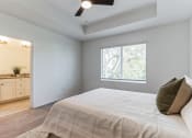 Thumbnail 13 of 30 - Boatman Hammock Townhomes in Lake Worth, FL photo of an empty bedroom with a large bed and a window