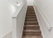 Thumbnail 27 of 30 - Boatman Hammock Townhomes in Lake Worth, FL photo of an image of a staircase with carpeted stairs and white railings