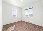 Thumbnail 12 of 26 - A room with carpeted floor and two windows.