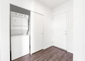 Thumbnail 10 of 26 - A white oven and fridge in a small room with wooden floors.