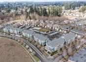 Thumbnail 26 of 26 - A large apartment complex with a parking lot in front.