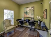 Thumbnail 10 of 13 - A room with a desk and chairs.