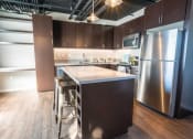 Thumbnail 14 of 19 - kitchen with wood-style flooring in specific apartments