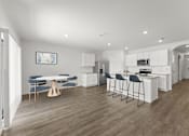 Thumbnail 9 of 35 - A modern kitchen with a dining table and chairs.